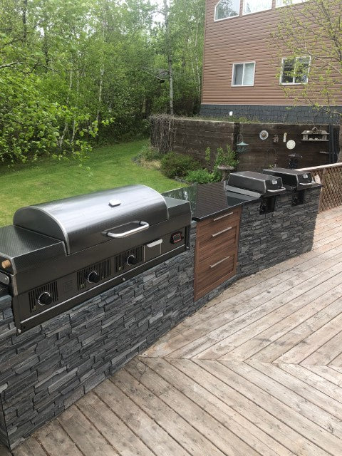Outdoor kitchen with barbecue grill on a wooden deck